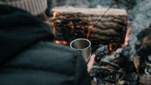 person holding stainless steel cup